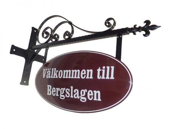 Röd/vit Emaljskylt med texten Välkommen till Bergslagen